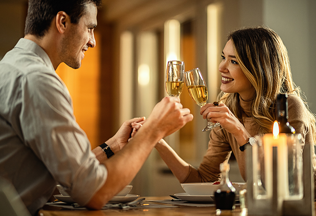 7-Types-of-Guys-Women-Find-Irresistible-1 Couple enjoying their dating with a glass of Champagne